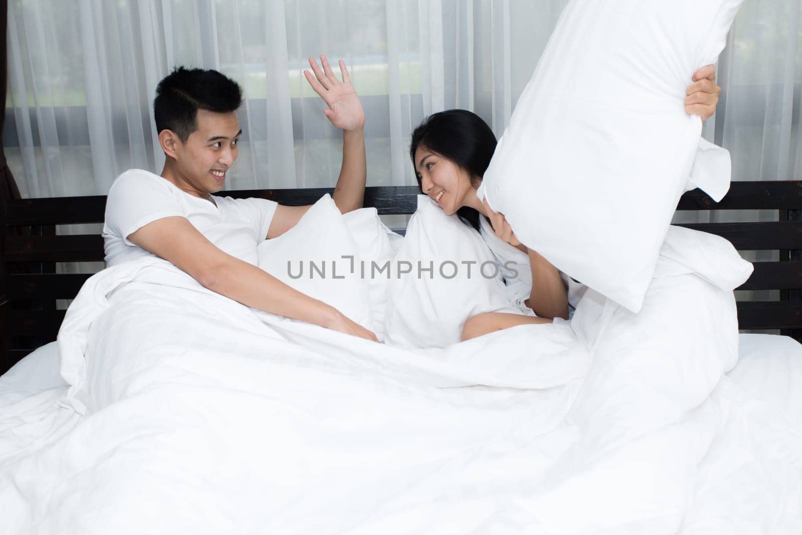 Young loving couple on the bed in the morning