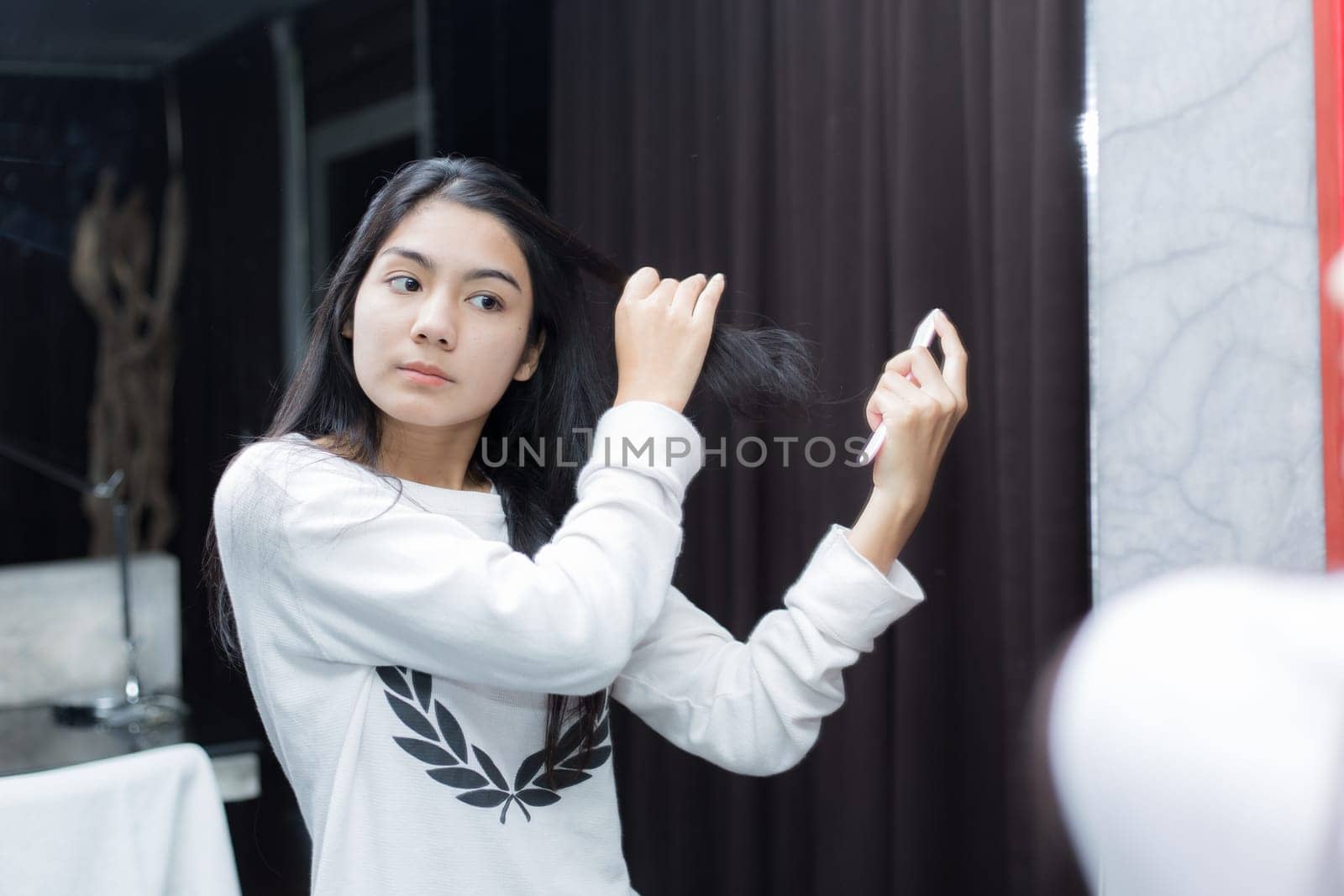 Young asian woman taking photos in autumn forest with camera