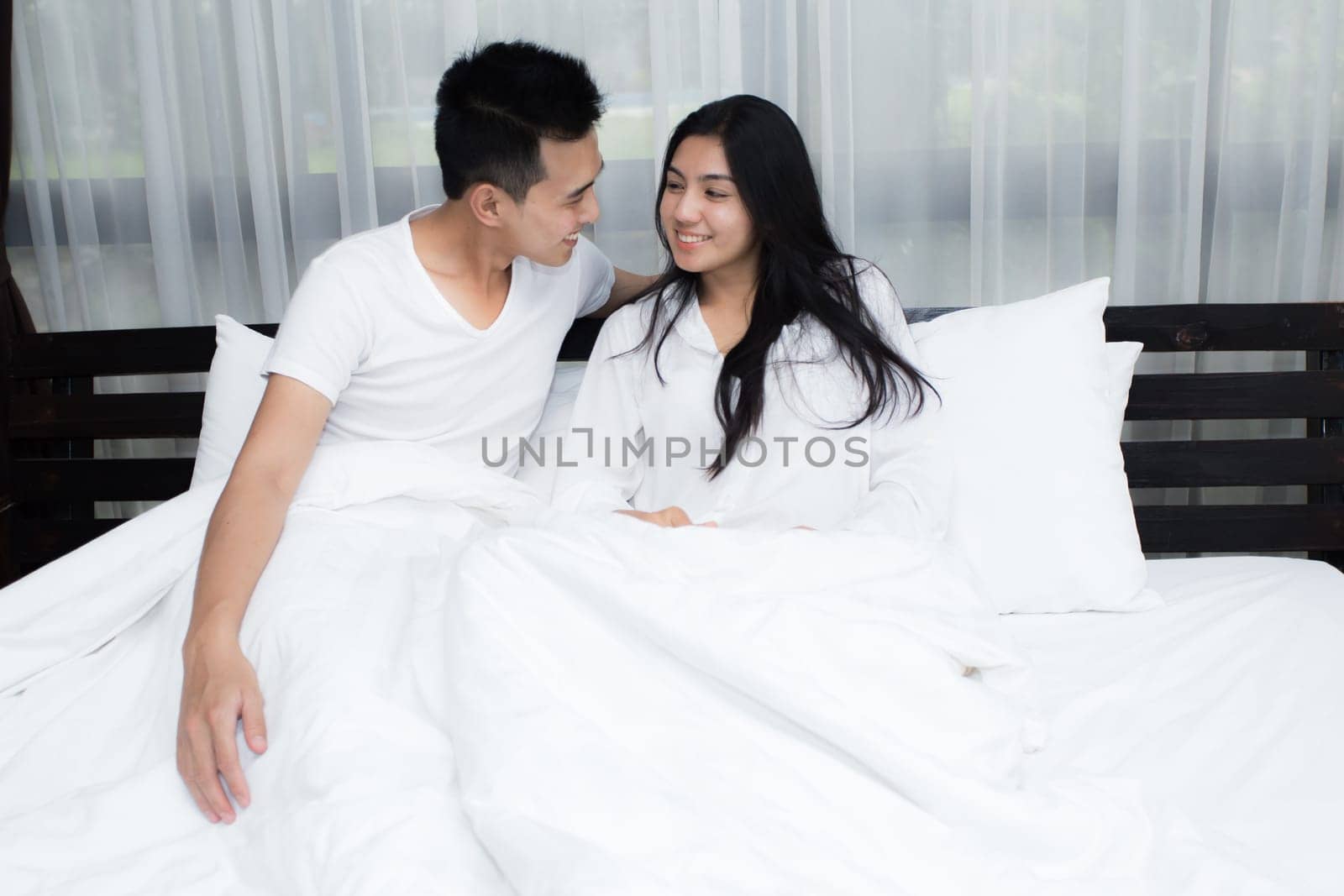 Young loving couple on the bed in the morning