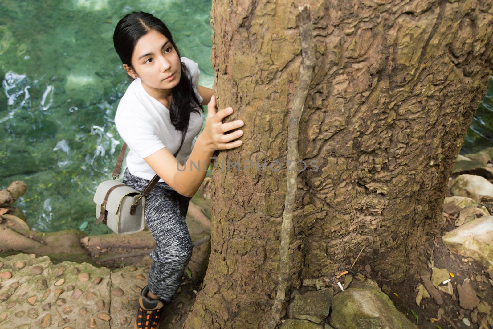 Young asian woman near public board with map, routes and locations