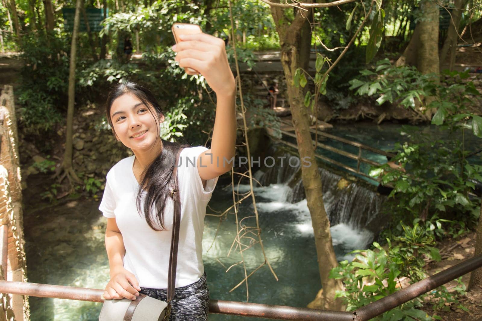 Young asian woman near public board with map, routes and locations