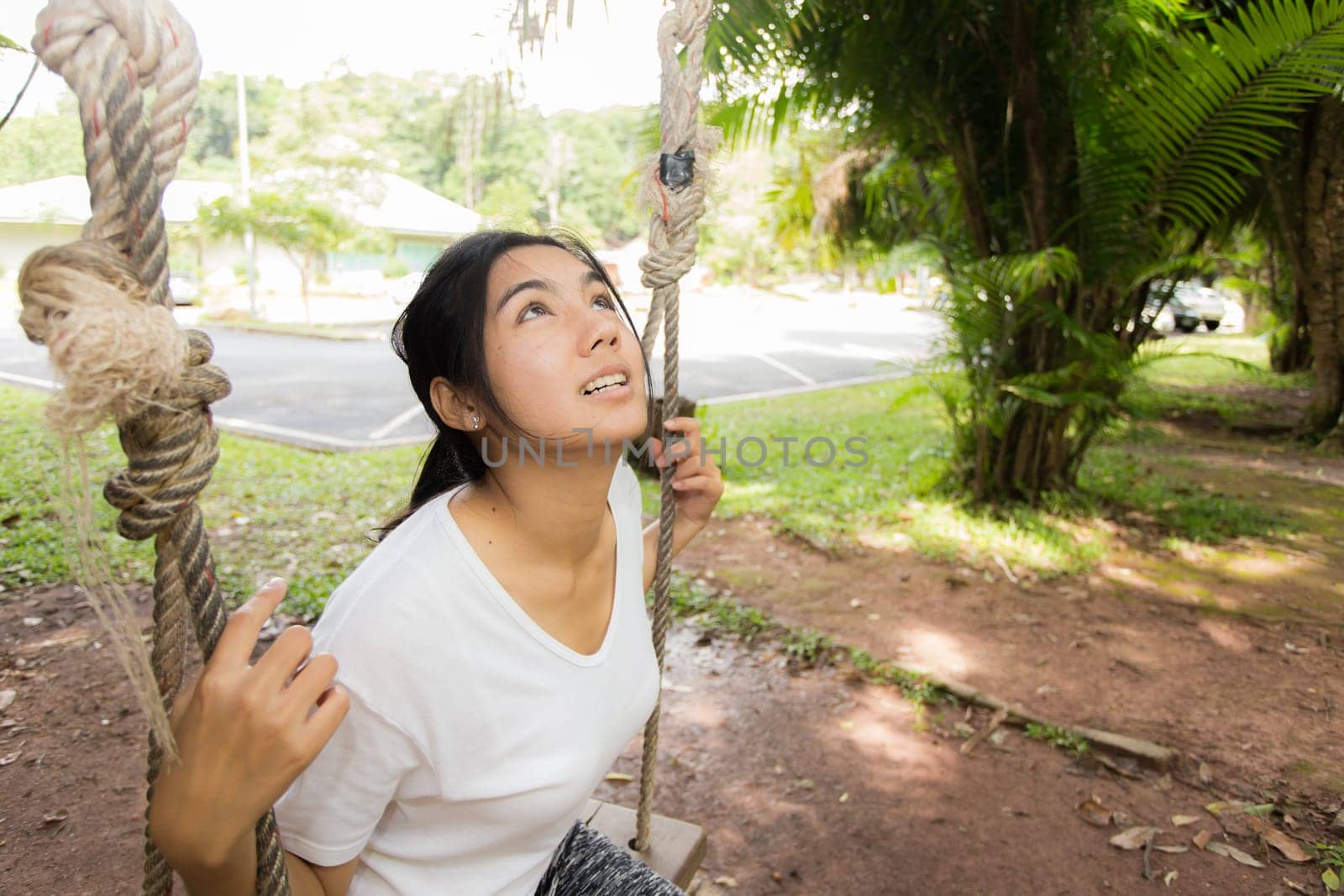 Young asian woman near public board with map, routes and locations