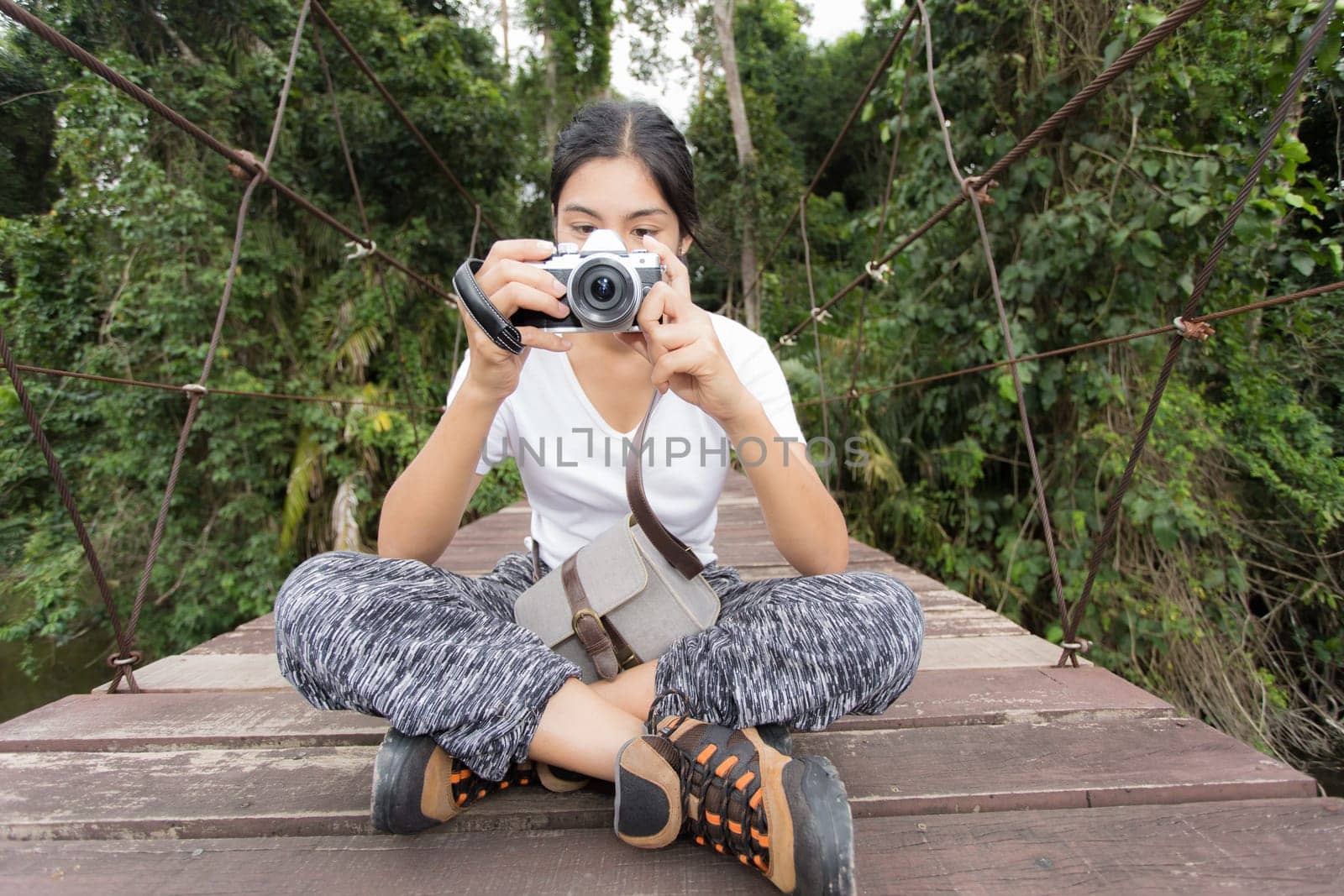 Young asian woman near public board with map, routes and locations