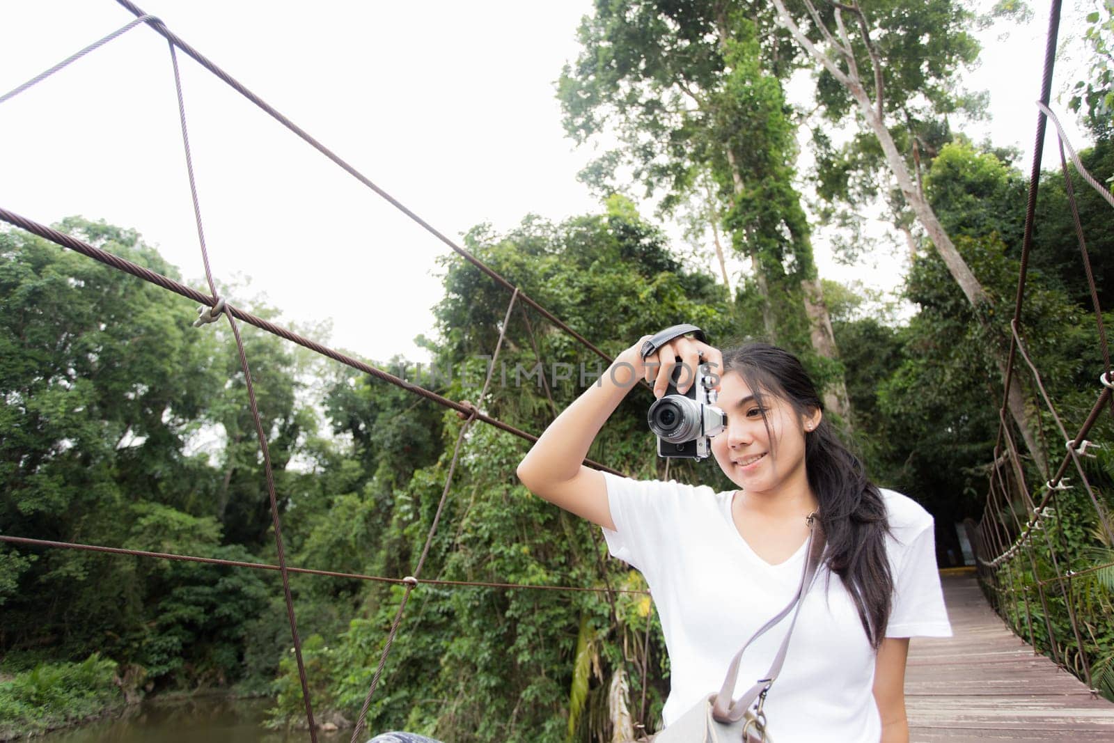 Young asian woman near public board with map, routes and locations