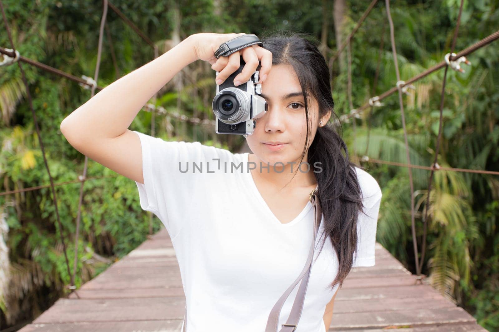 Young asian woman near public board with map, routes and locations