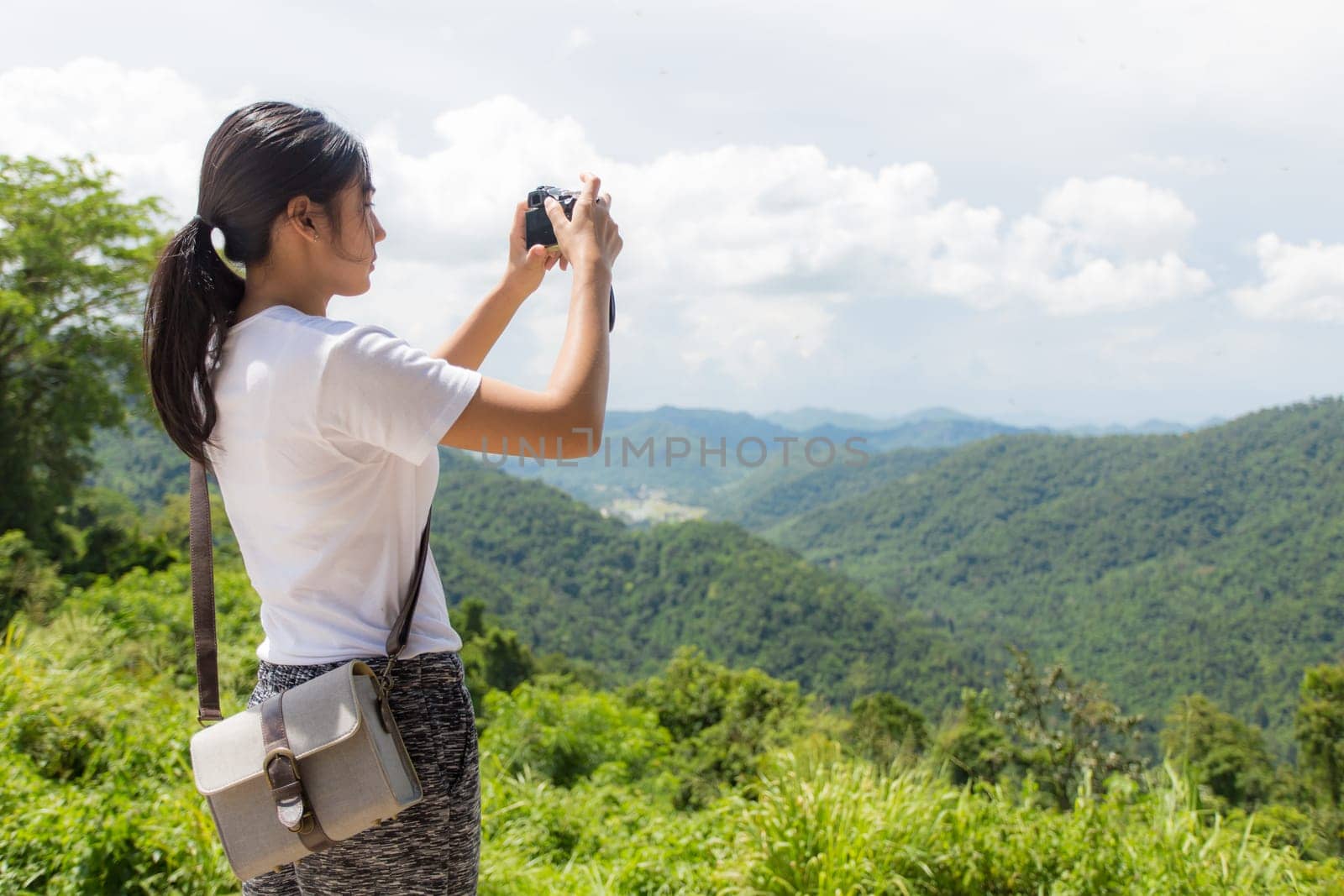Young asian woman near public board with map, routes and locations
