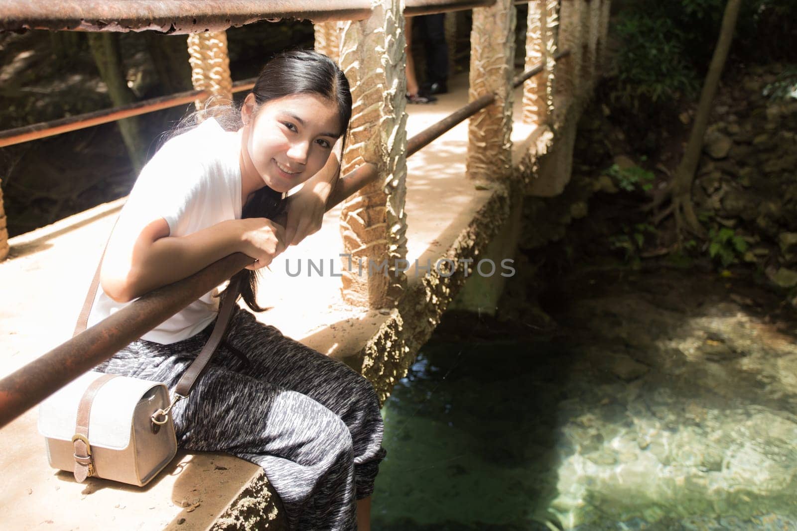 Young asian woman near public board with map, routes and locations