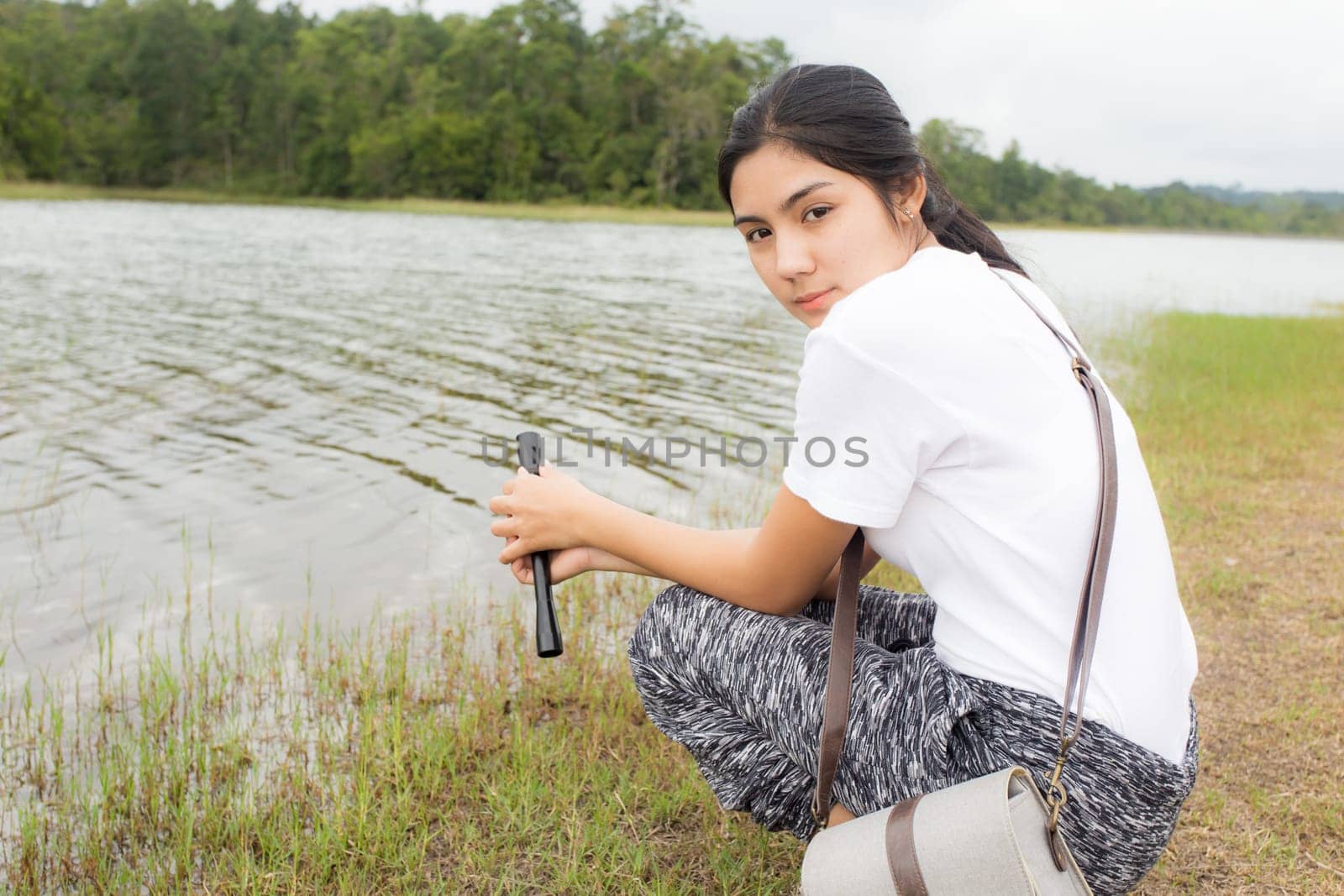 Beautiful smiling young asian woman enjoying yoga, relaxing, feeling alive, breathing fresh air, got freedom from work
