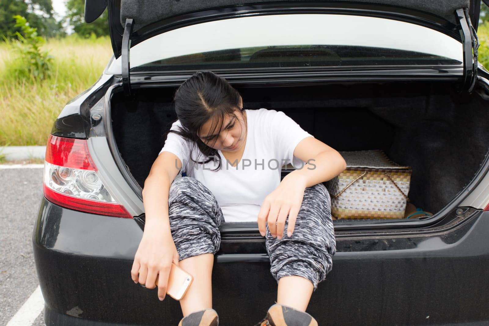 Woman opened the hood Broken car on the side See engines that are damaged or not
