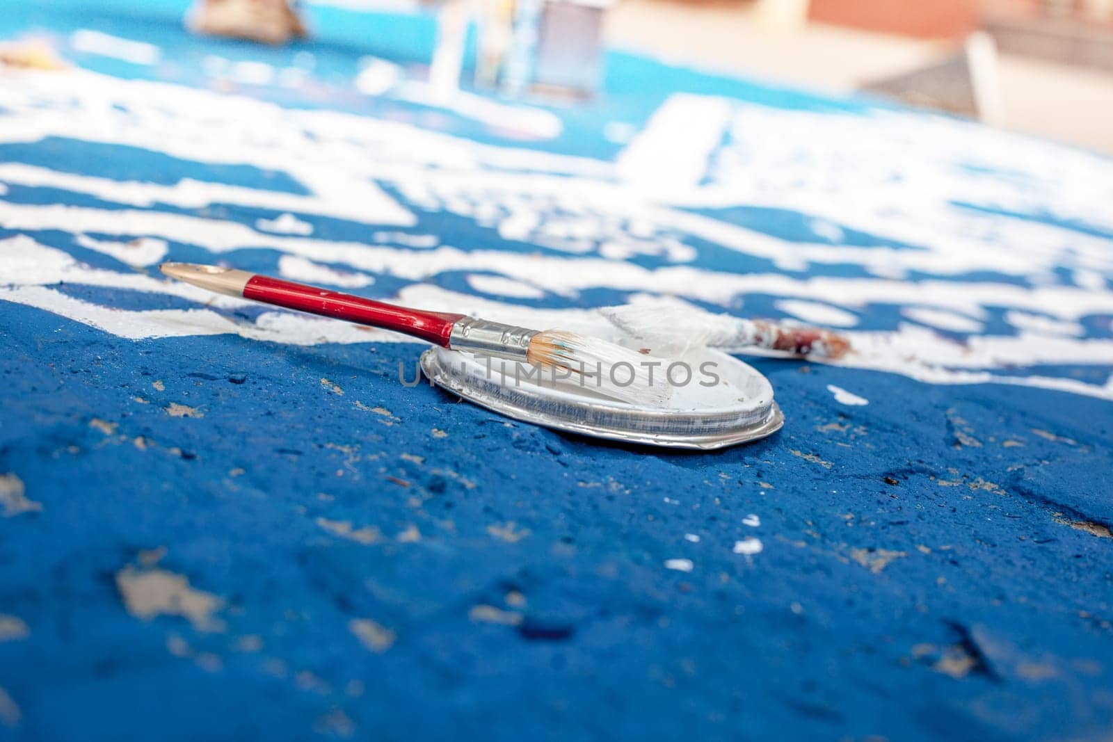 Tools of the street artist and colored pattern on a street of abstract city. Selective focus