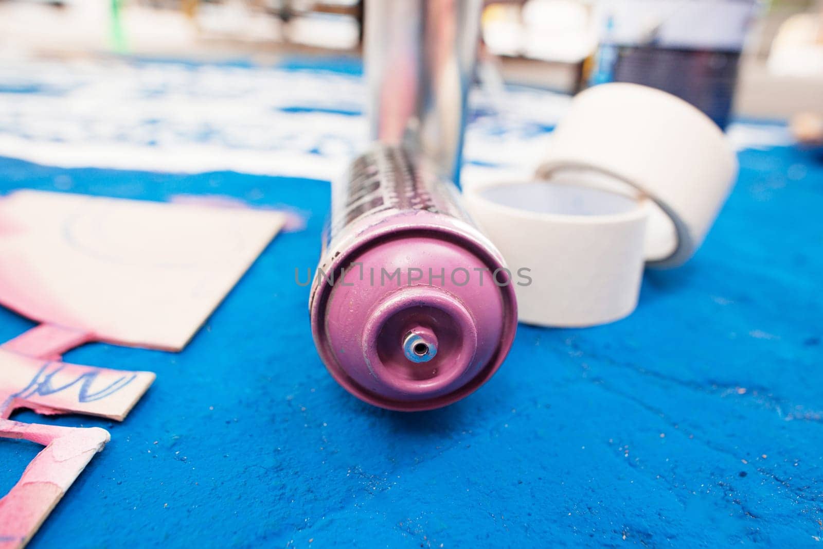 Tools of the street artist and colored pattern on a street of abstract city
