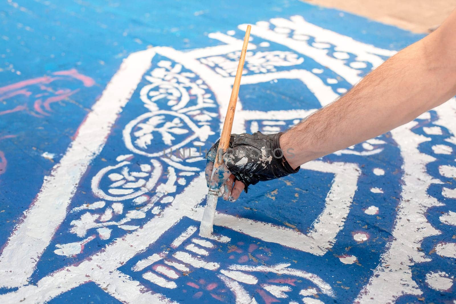 Tools of the street artist and colored pattern on a street of abstract city