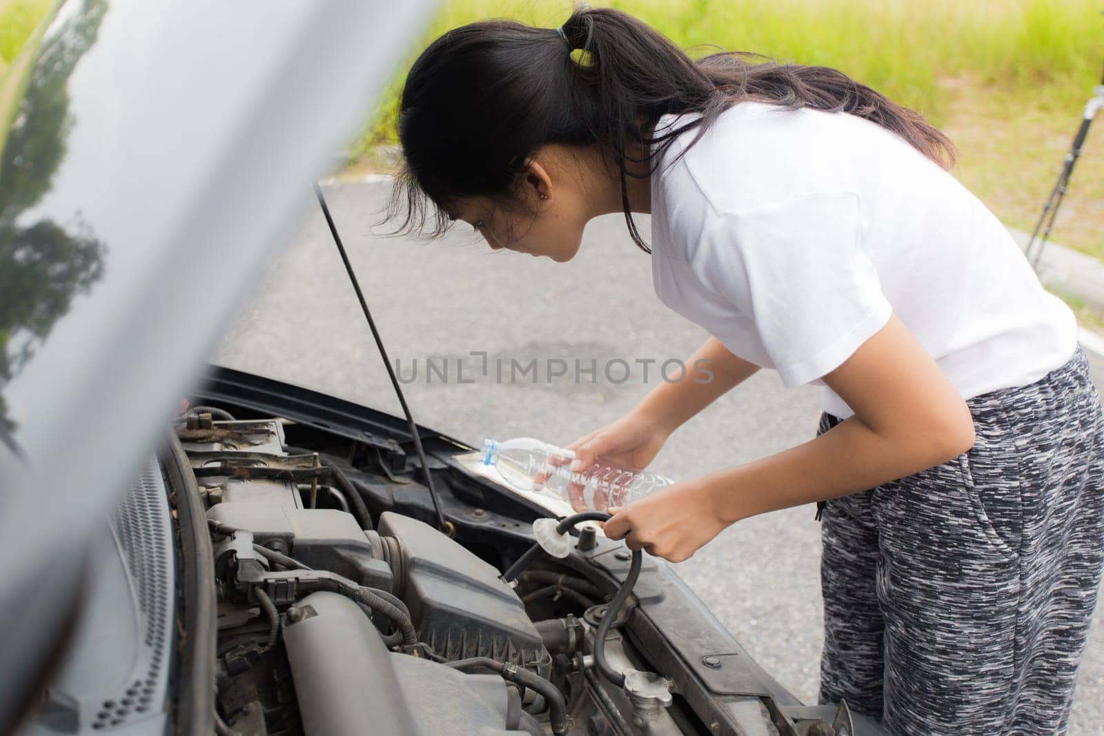 Woman opened the hood Broken car on the side See engines that are damaged or not