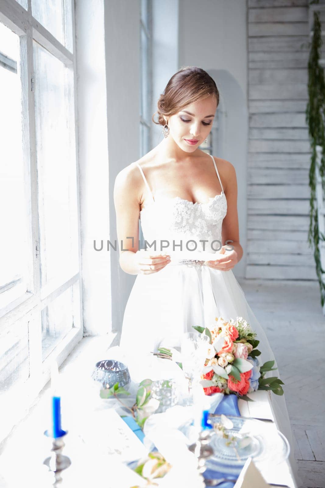 The beautiful bride in wedding dress, white background