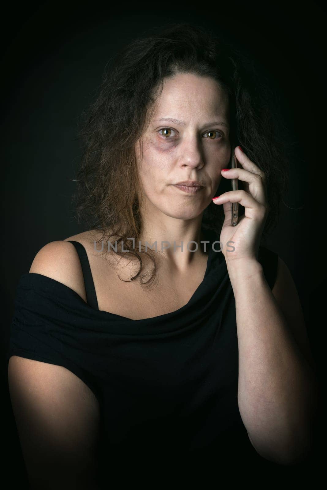 Scared woman calling for help, victim of domestic violence