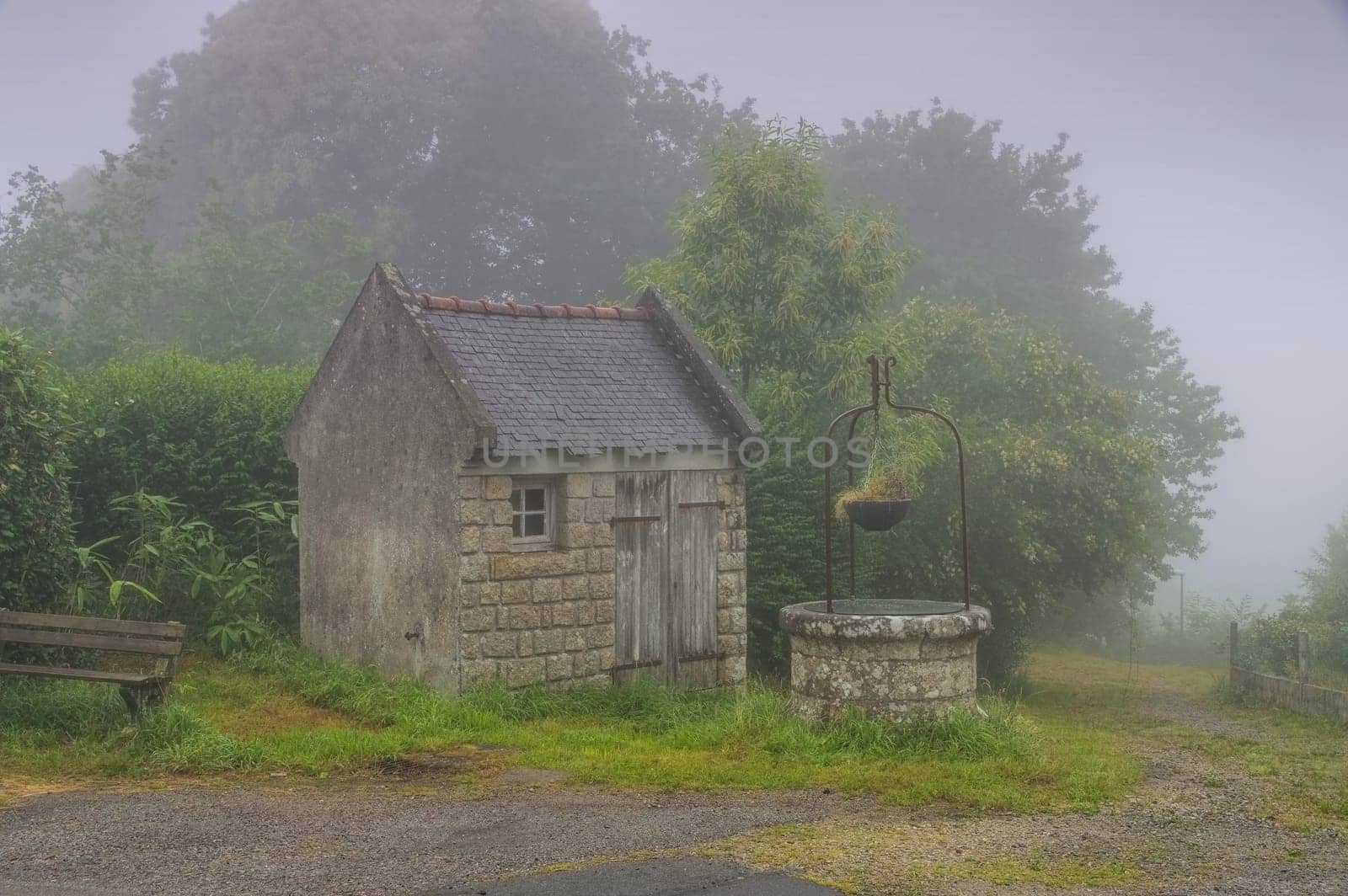 the medieval village of Locronan well in fog in Brittany,France - medieval village of Locronan well in fog,Brittany in France