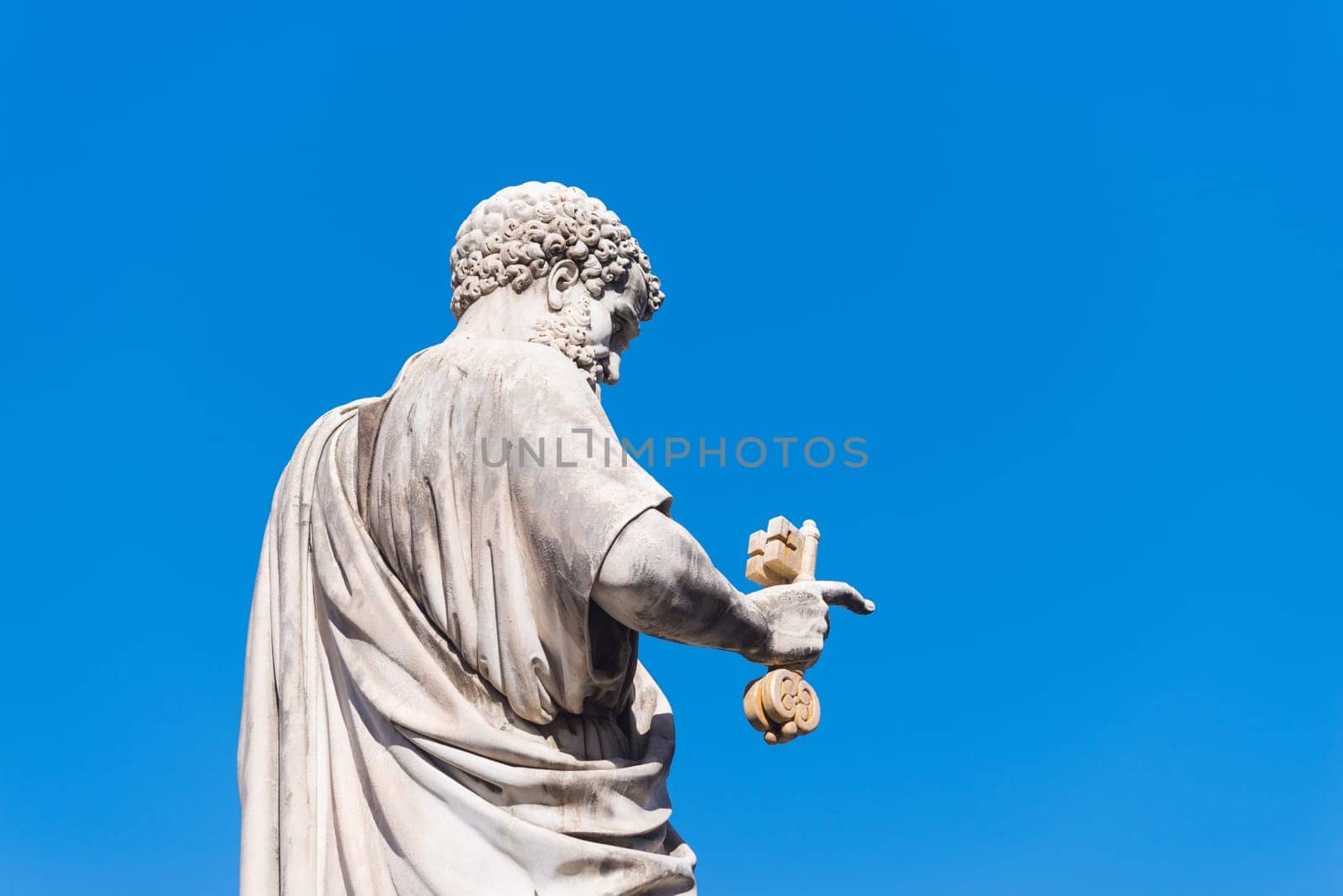 VATICAN CITY, VATICAN - OCTOBER 16, 2016: Statue Saint Peter holding a key in front of St Peter's Basilica on piazza San Pietro
