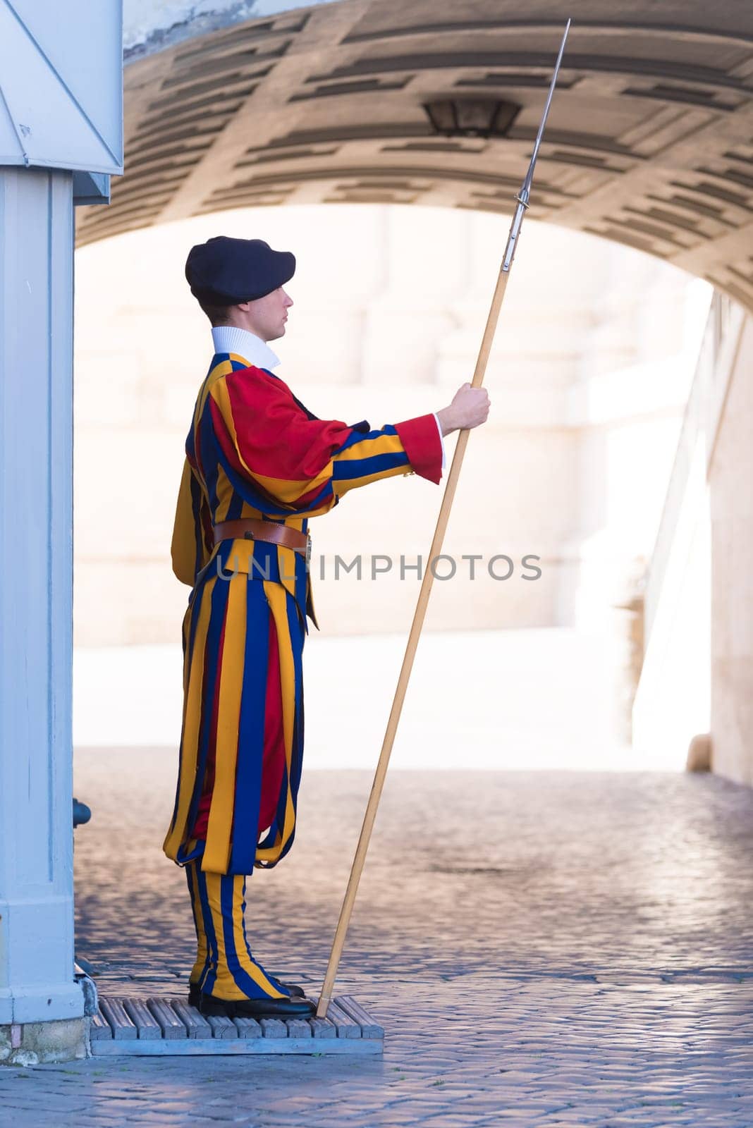 VATICAN CITY, VATICAN - OCTOBER 16, 2016: Famous Swiss Guard guarding the entrance to the Vatican City. The Papal Guard with about 100 men is the world's smallest army.