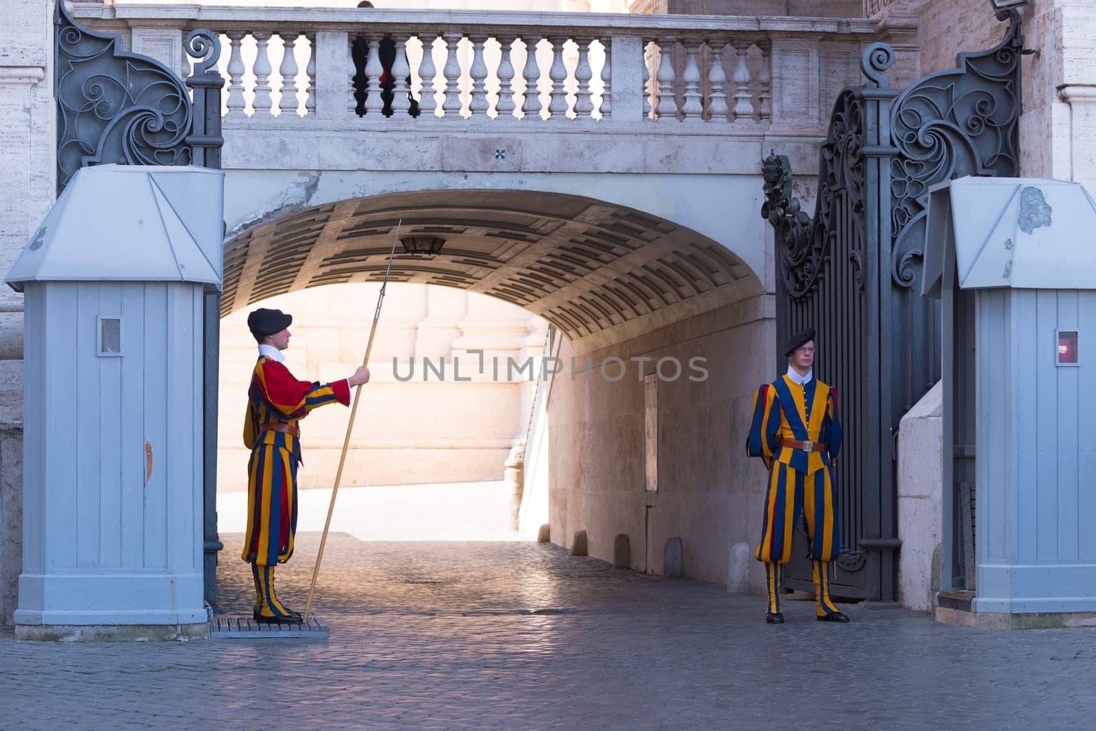 VATICAN CITY, VATICAN - OCTOBER 16, 2016: Famous Swiss Guard guarding the entrance to the Vatican City. The Papal Guard with about 100 men is the world's smallest army.