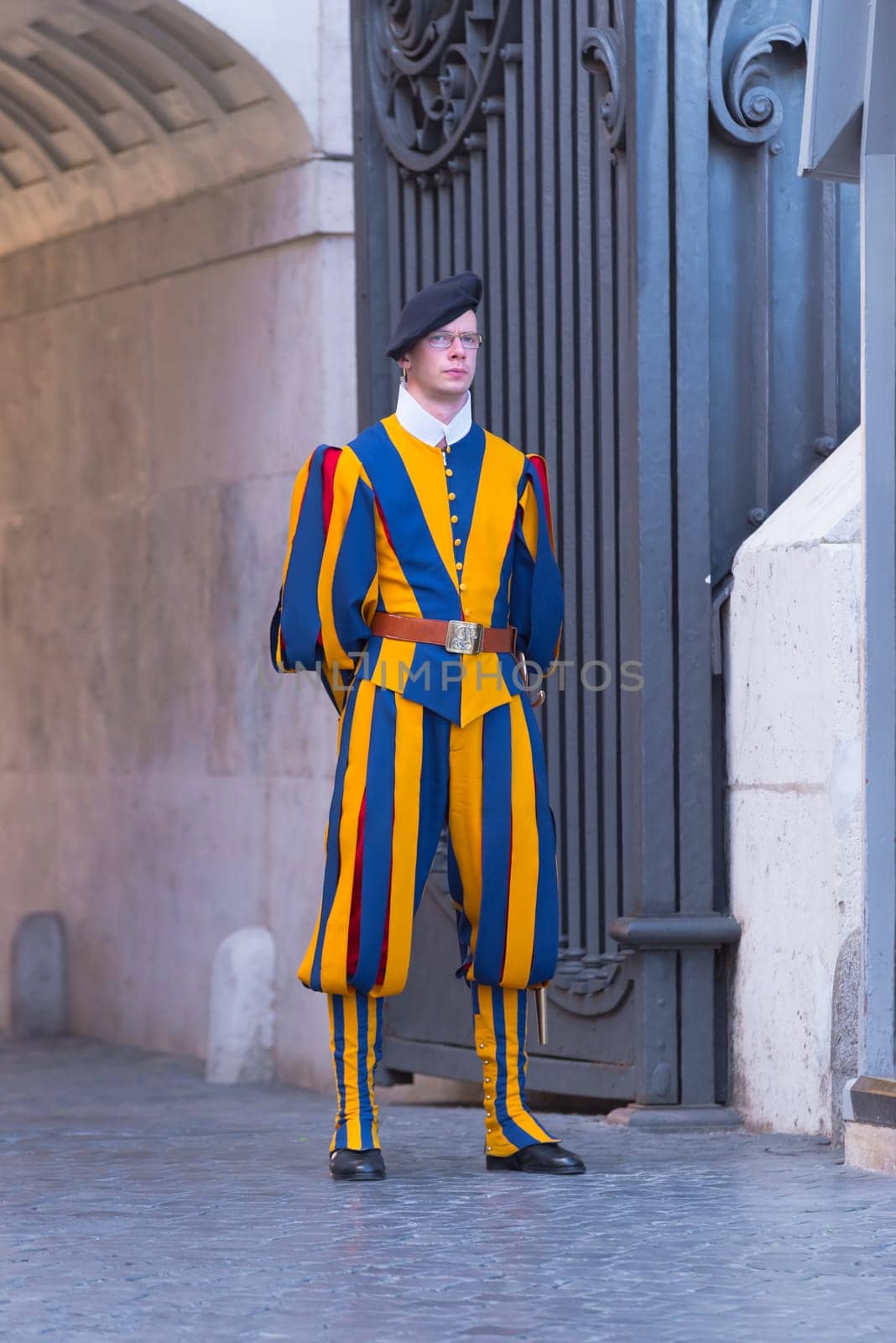 VATICAN CITY, VATICAN - OCTOBER 16, 2016: Famous Swiss Guard guarding the entrance to the Vatican City. The Papal Guard with about 100 men is the world's smallest army.