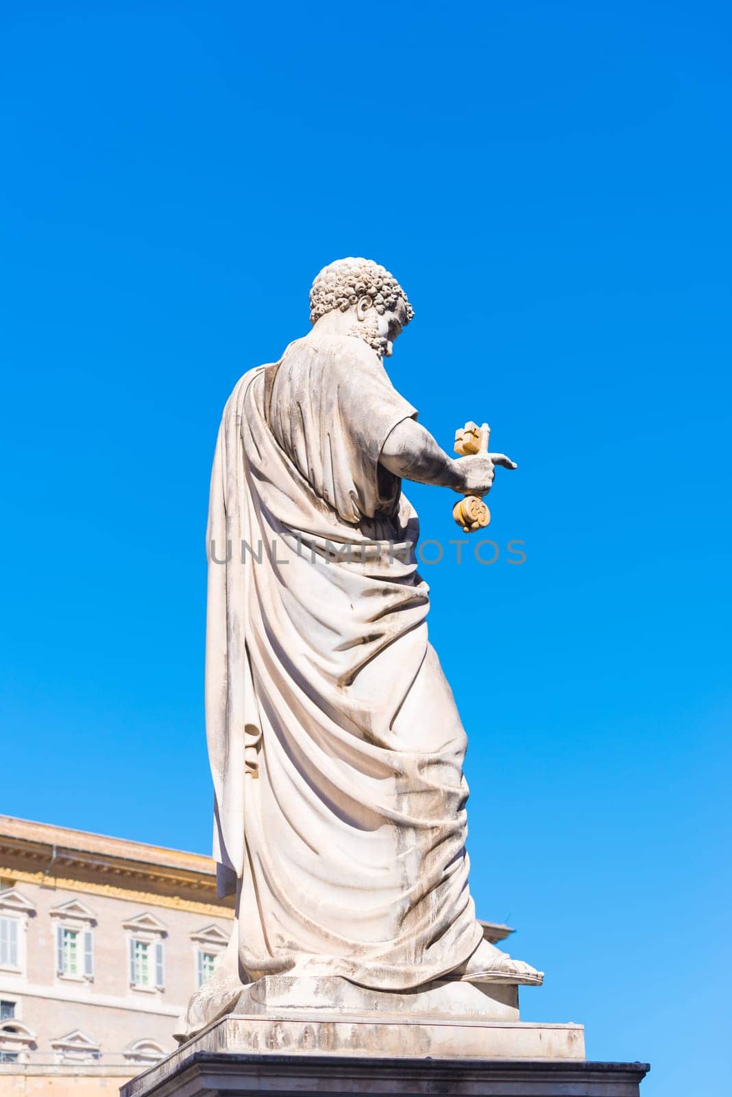 VATICAN CITY, VATICAN - OCTOBER 16, 2016: Statue Saint Peter holding a key in front of St Peter's Basilica on piazza San Pietro