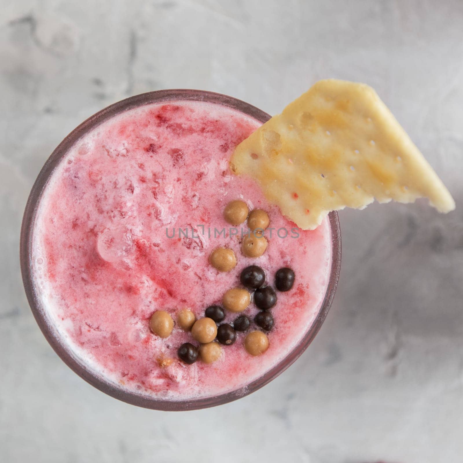 Strawberry smoothie with cookie on a white concrete background. Square cropping