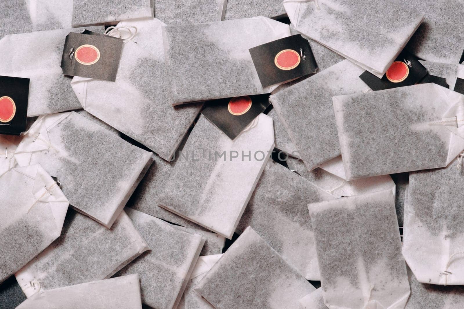 Tea bags on a dark background, stand in a row