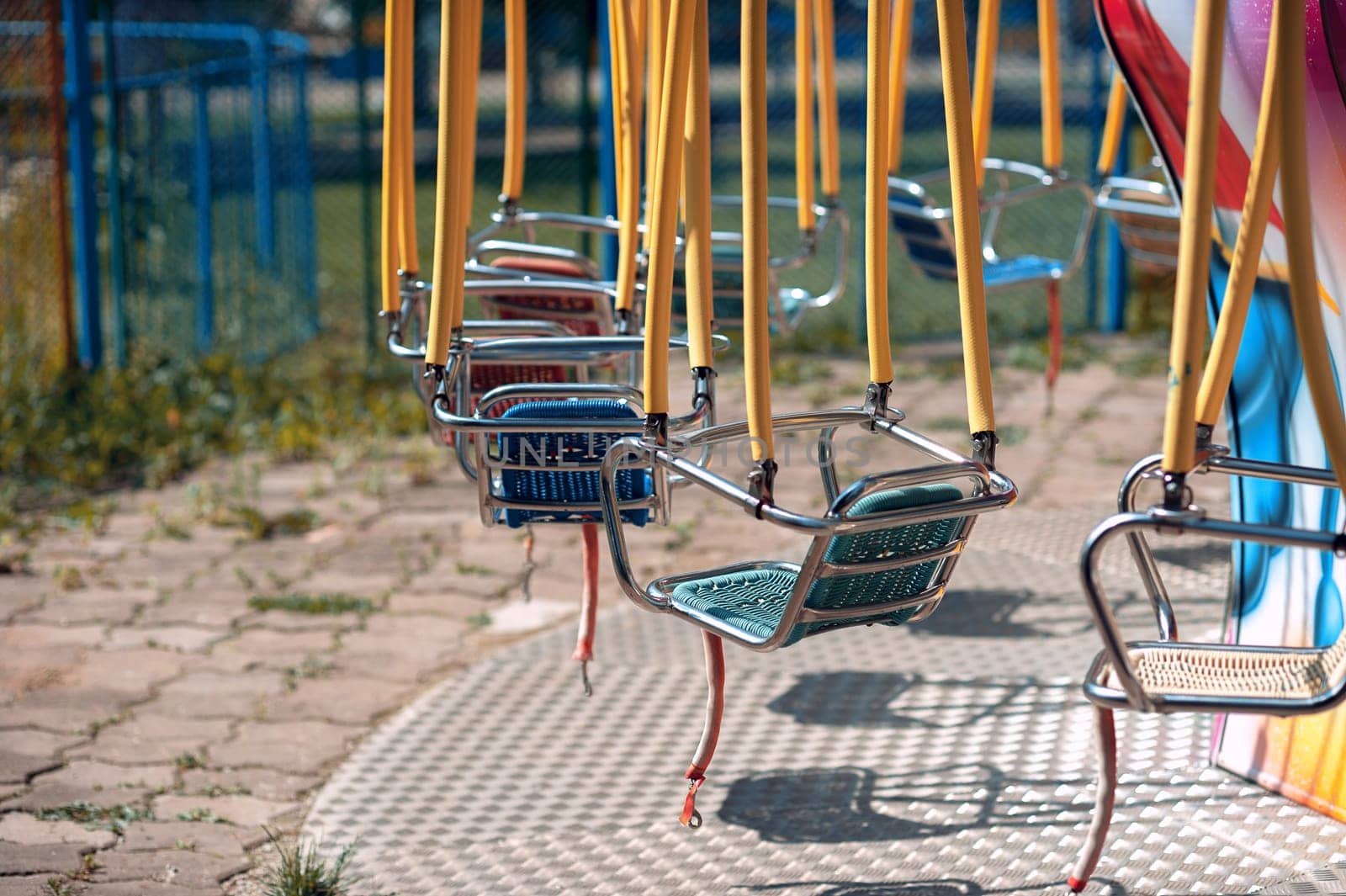 Summer playground in the park, swing carousel without people
