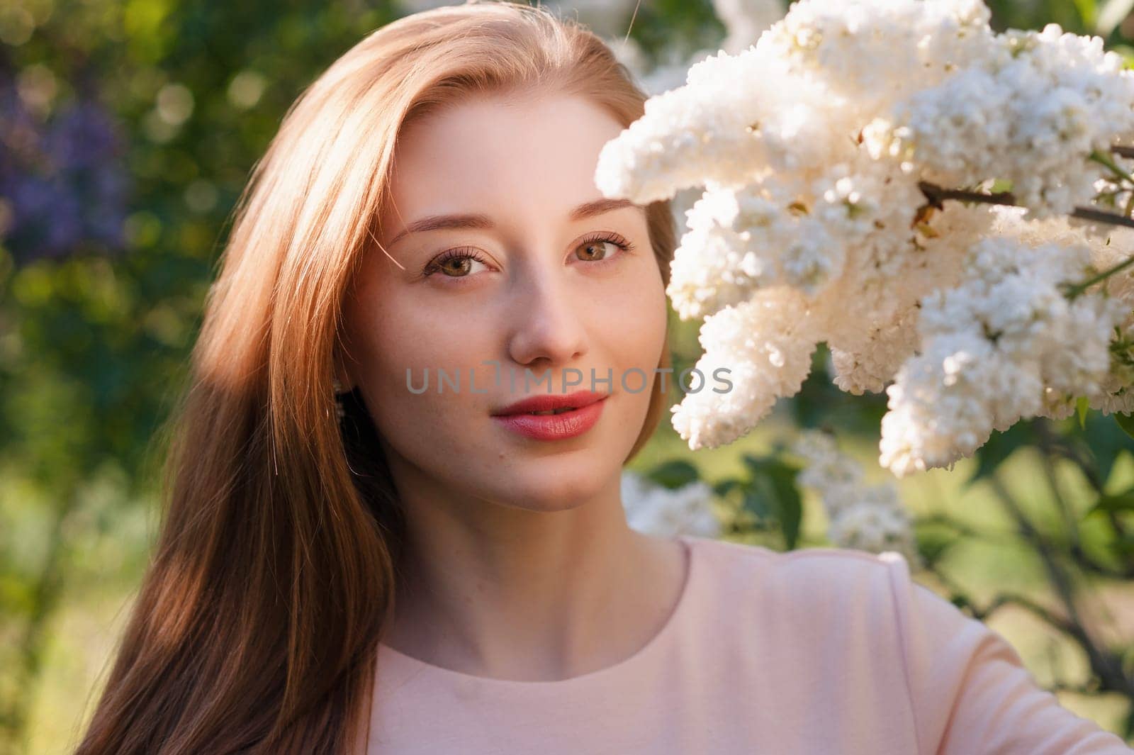 Beautiful woman with flowers of lilac. Skincare