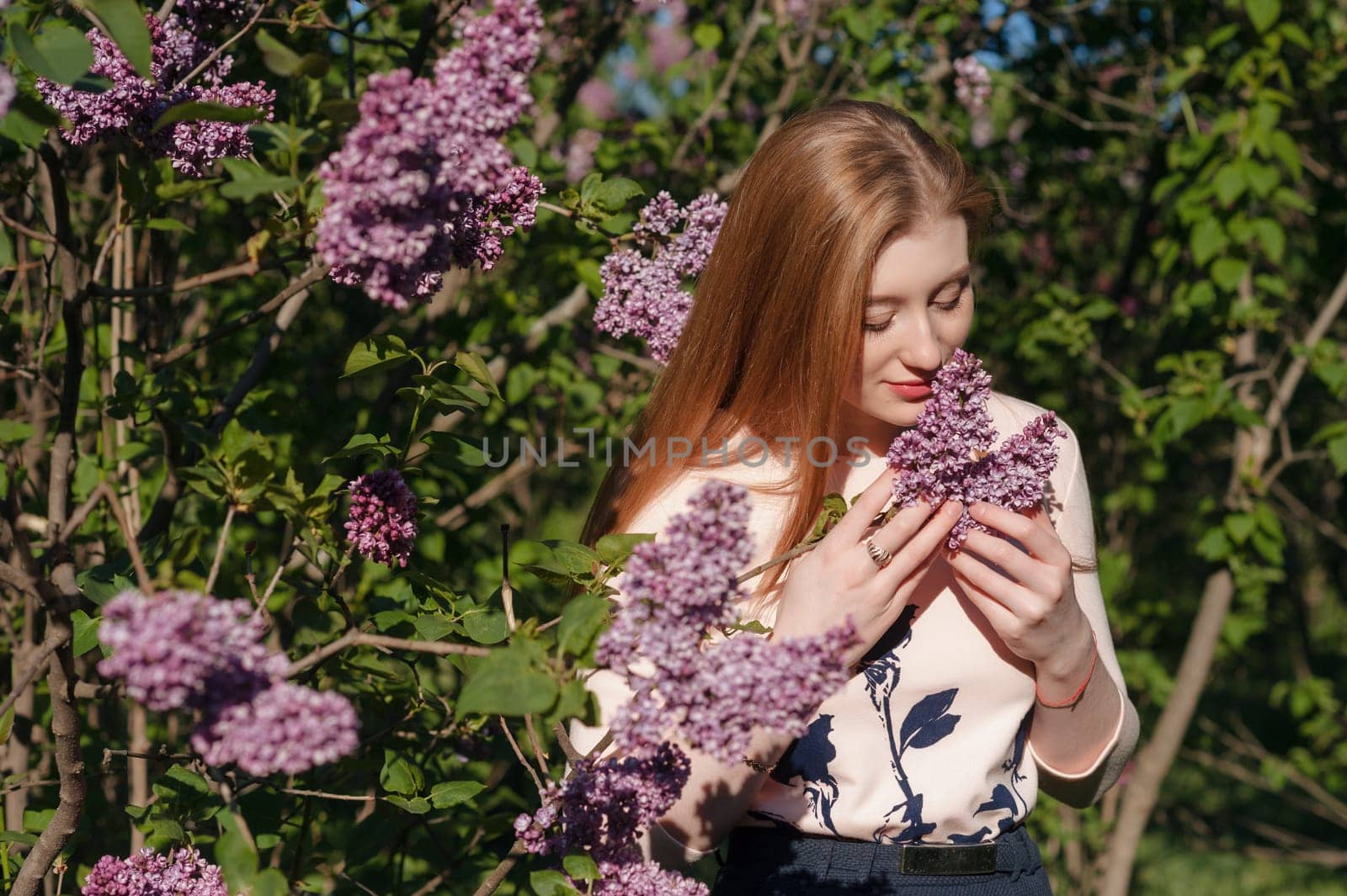 Beautiful woman with flowers of lilac. Skincare