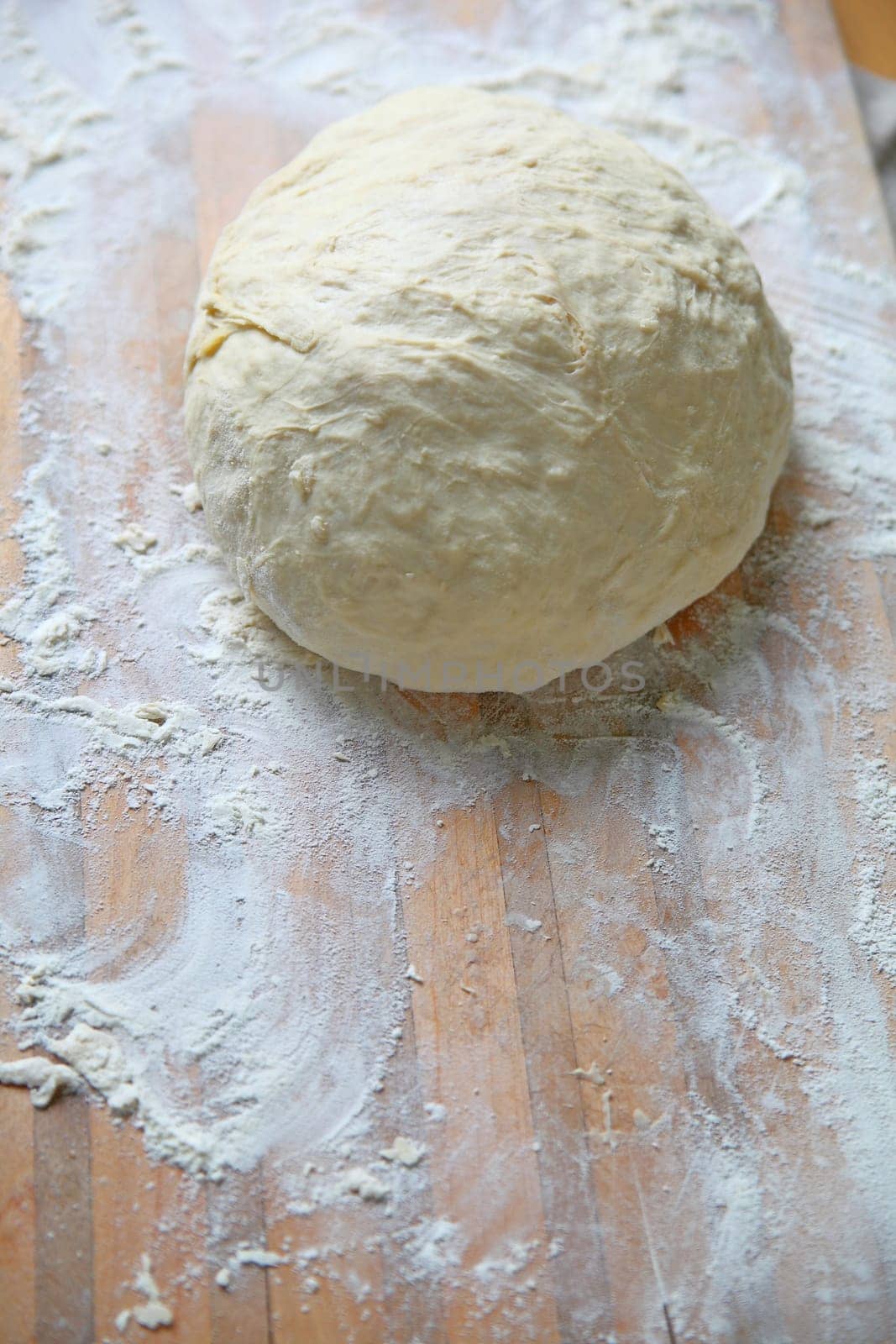 Overhead of bread dough on a floured wood cutting board