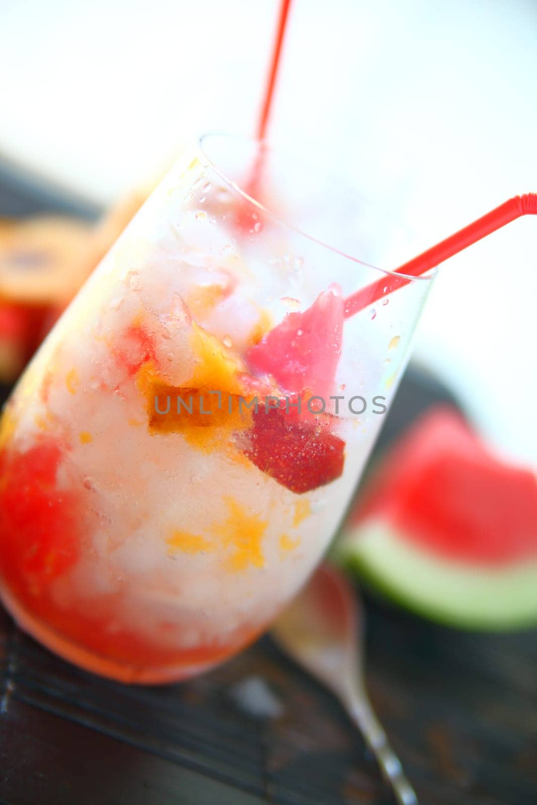 Icy drink made with watermelon, fresh peaches,  crushed ice and carbonated water with room for text