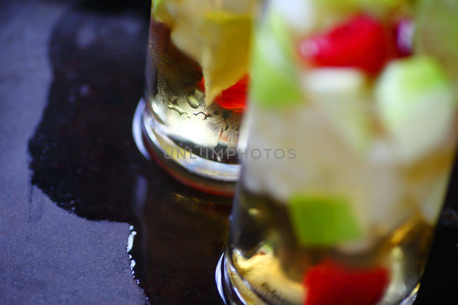 Cold wine cocktails with apple and fresh berries on a wet tray