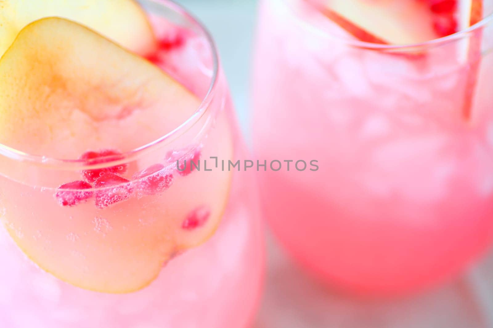 Cold wine cocktails with fresh pear and pomegranate seeds