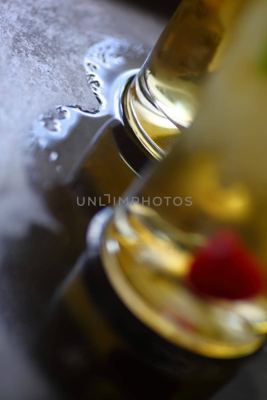Two wine cocktails on a metal tray with pool of water with room for text