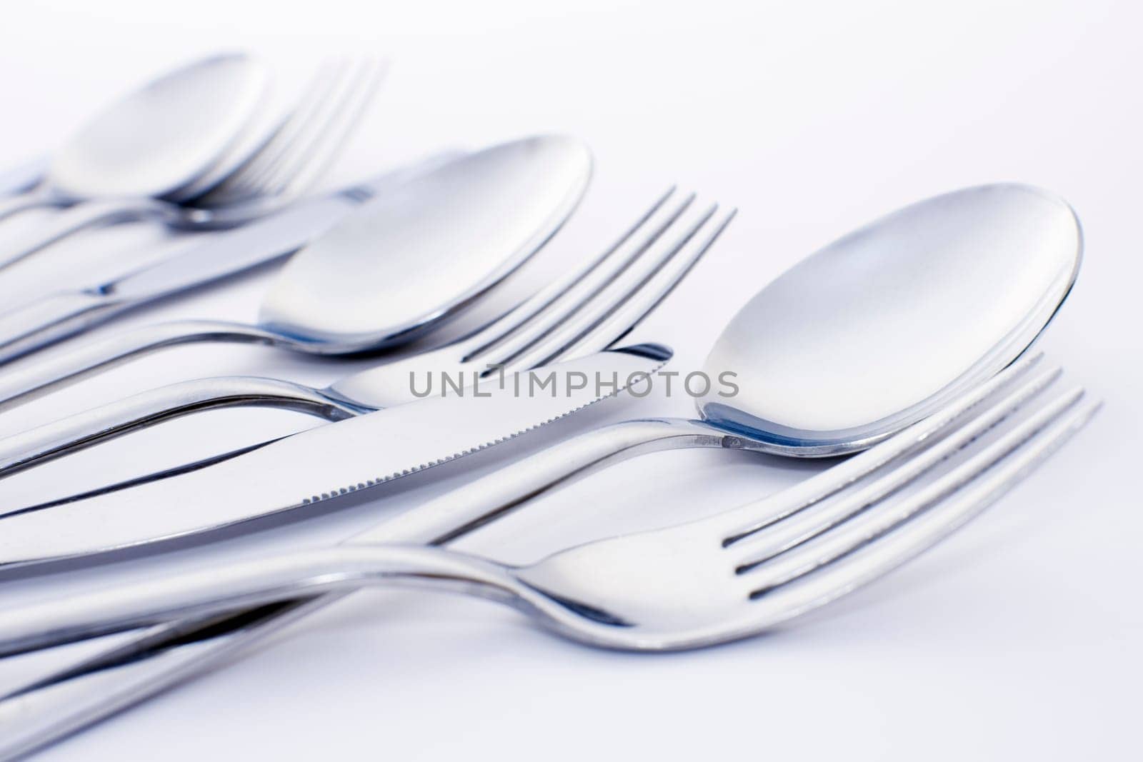 Forks spoons and knifes are on white background.