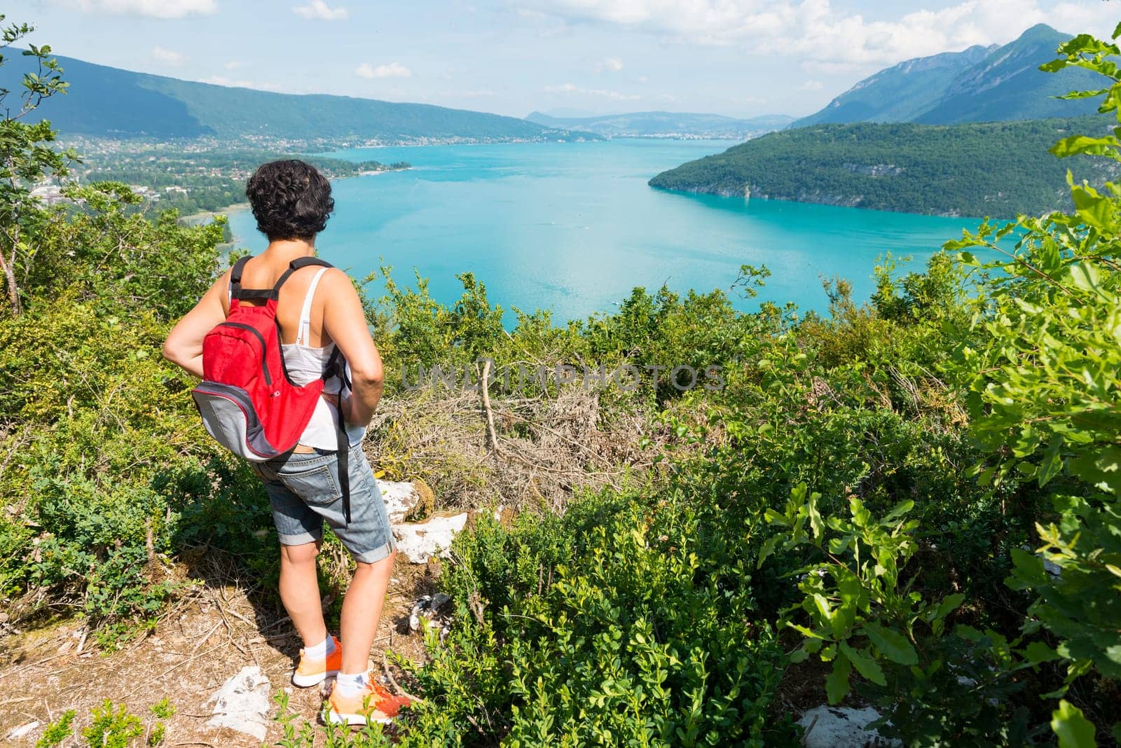 a woman watching view of Lake Annecy in the french Alps