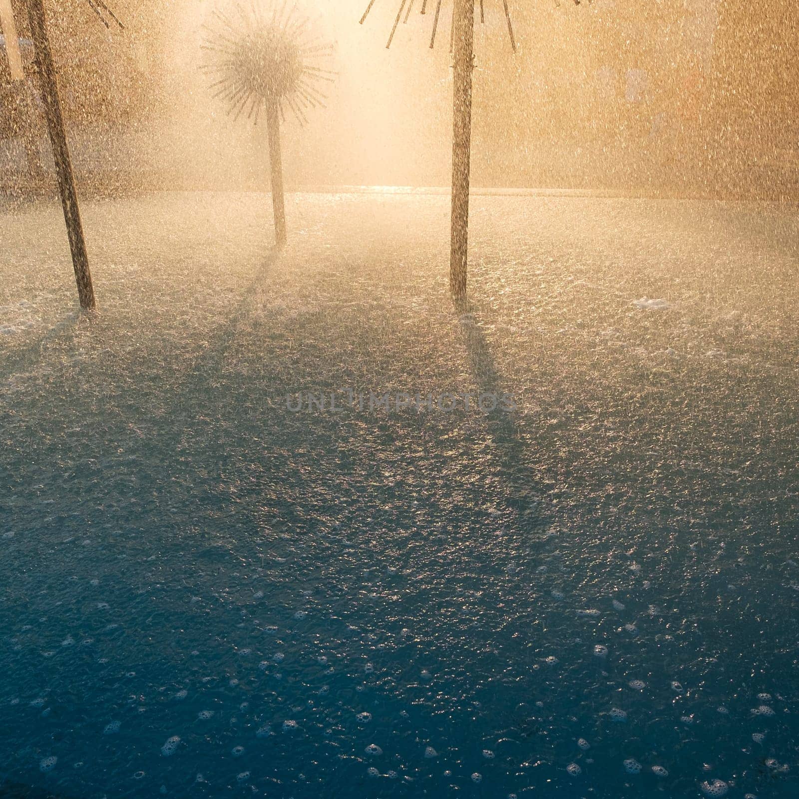 Fountains and splashes of water in the backlight of the sun