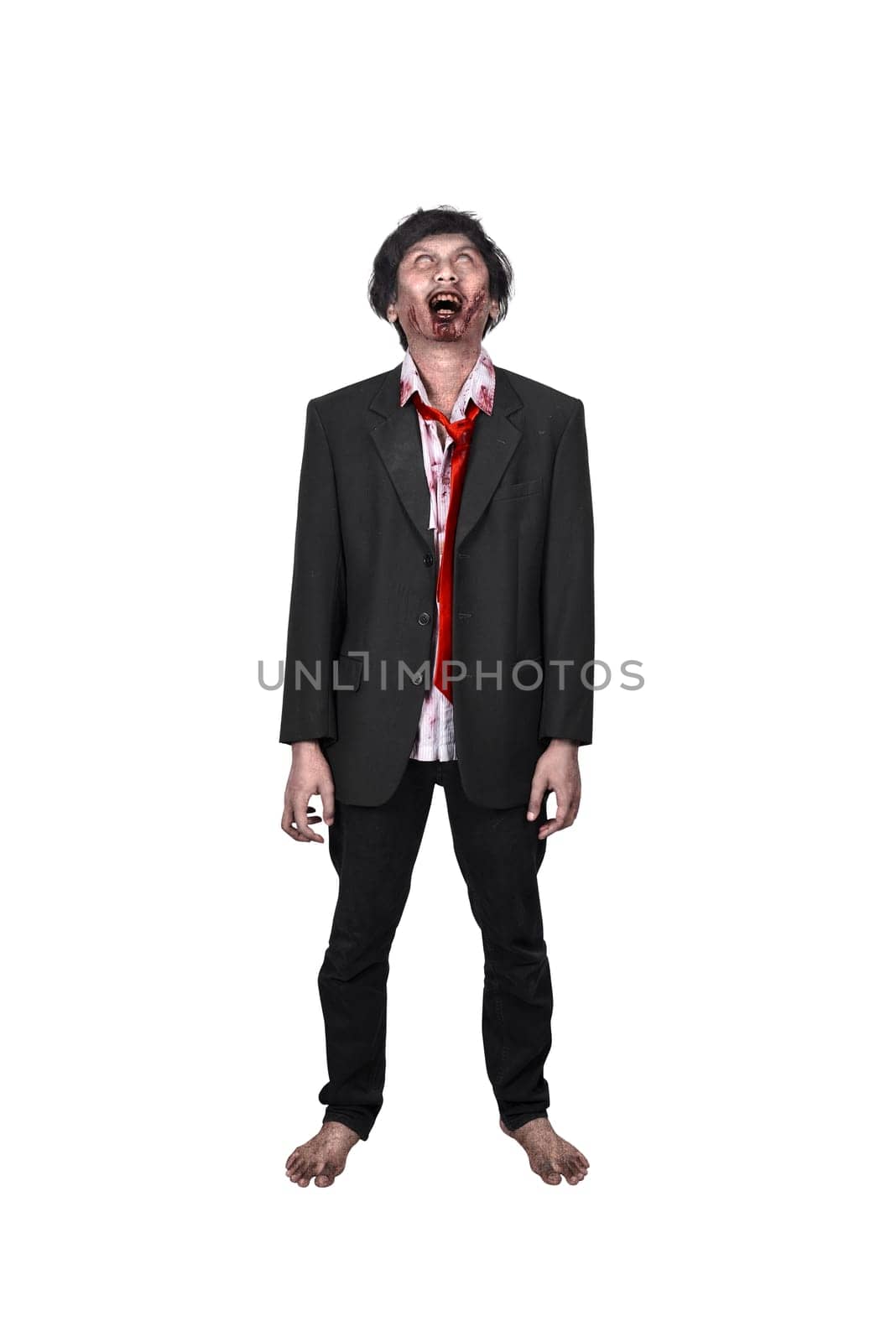 Portrait of creepy asian zombie man in suit standing isolated over white background