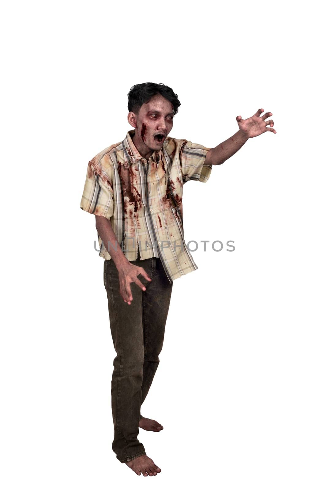 Portrait of asian zombie man with claw hand standing isolated over white background