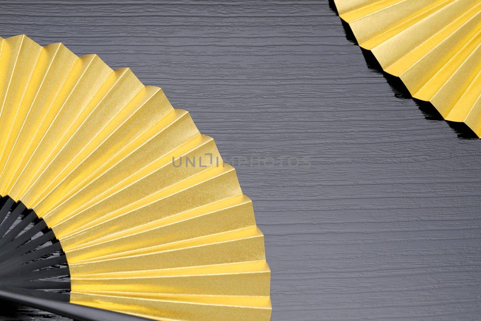 traditional chinese style golden hand fan on gray background　
