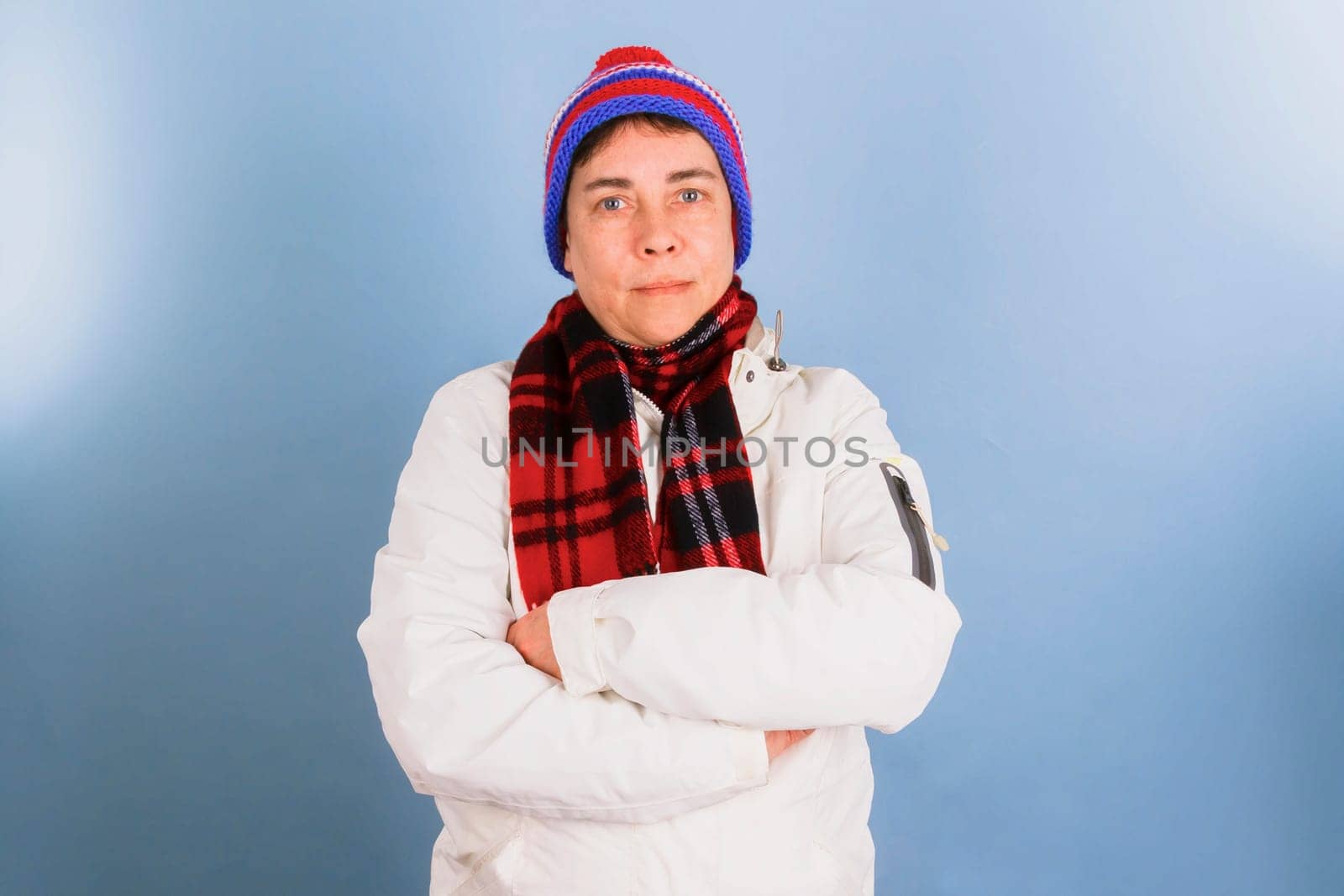 Woman with winter clothes shears arms