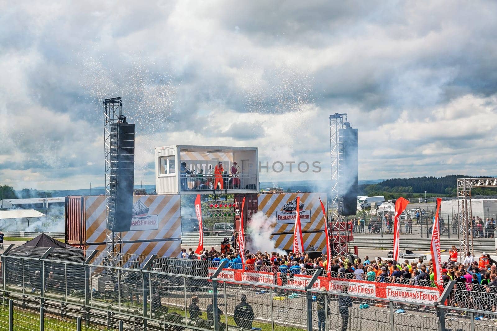 Nurburg, Germany - May 20, 2017: Fishermen's Friend Strongman RUN at race track Nurburgring - runners start with fireworks on start finishing straight in front of stage