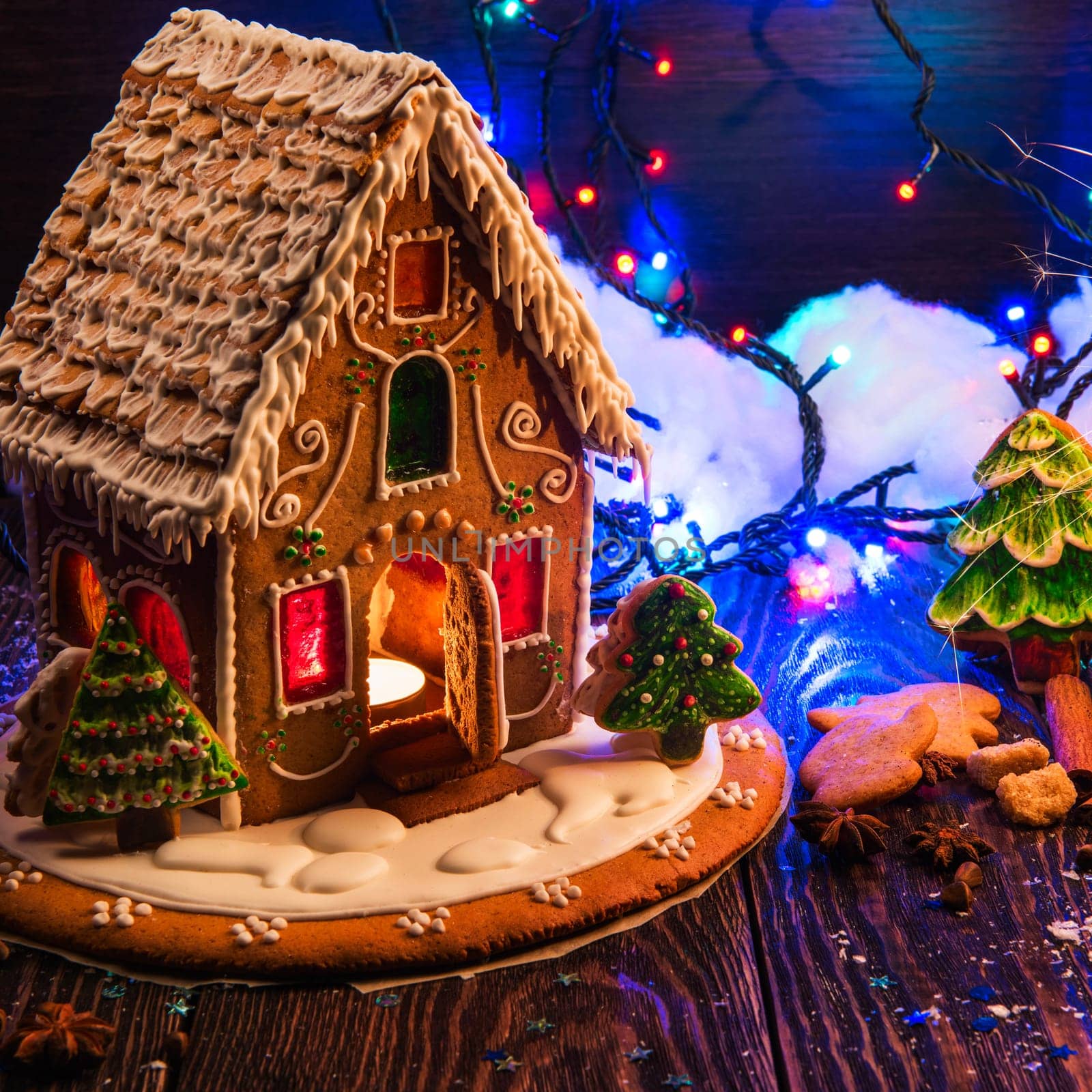 Gingerbread house with lights on dark background, xmas theme