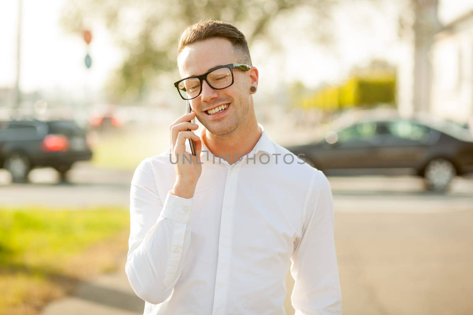 Man with glasses speak on mobile phone, In City, Urban Space, Park