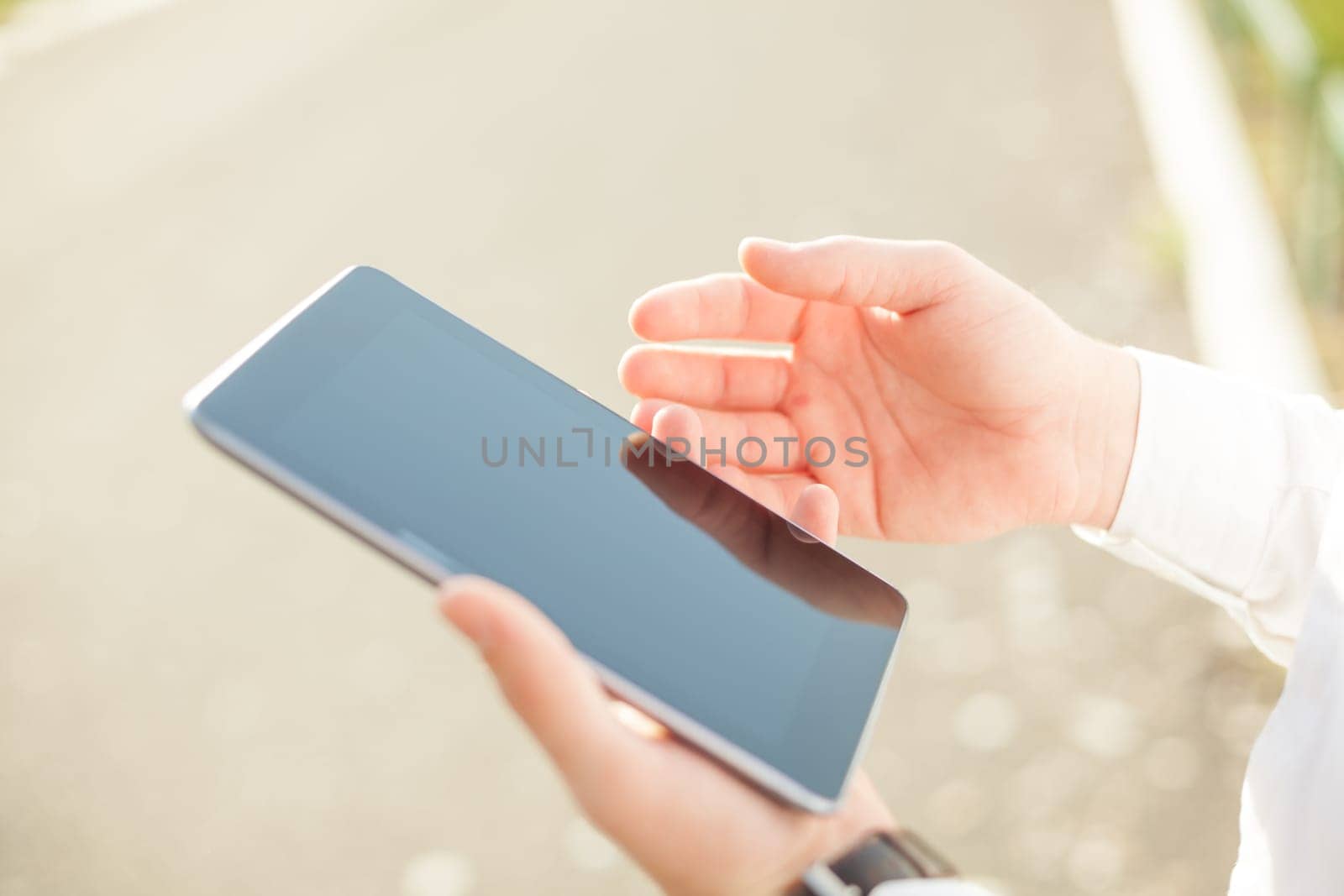 Close up of young man hands using touchscreen on digital tablet