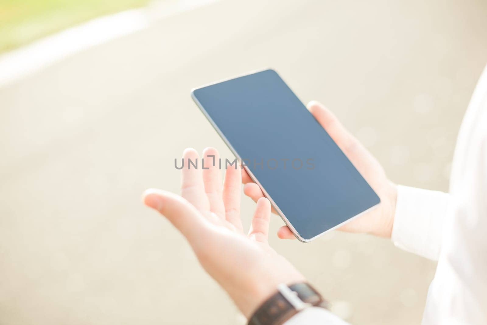 Close up of young man hands using touchscreen on digital tablet