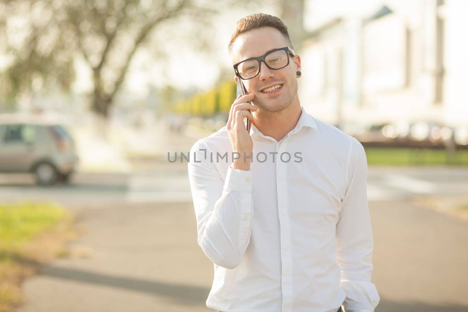 Man with glasses speak on mobile phone, In City, Urban Space, Park