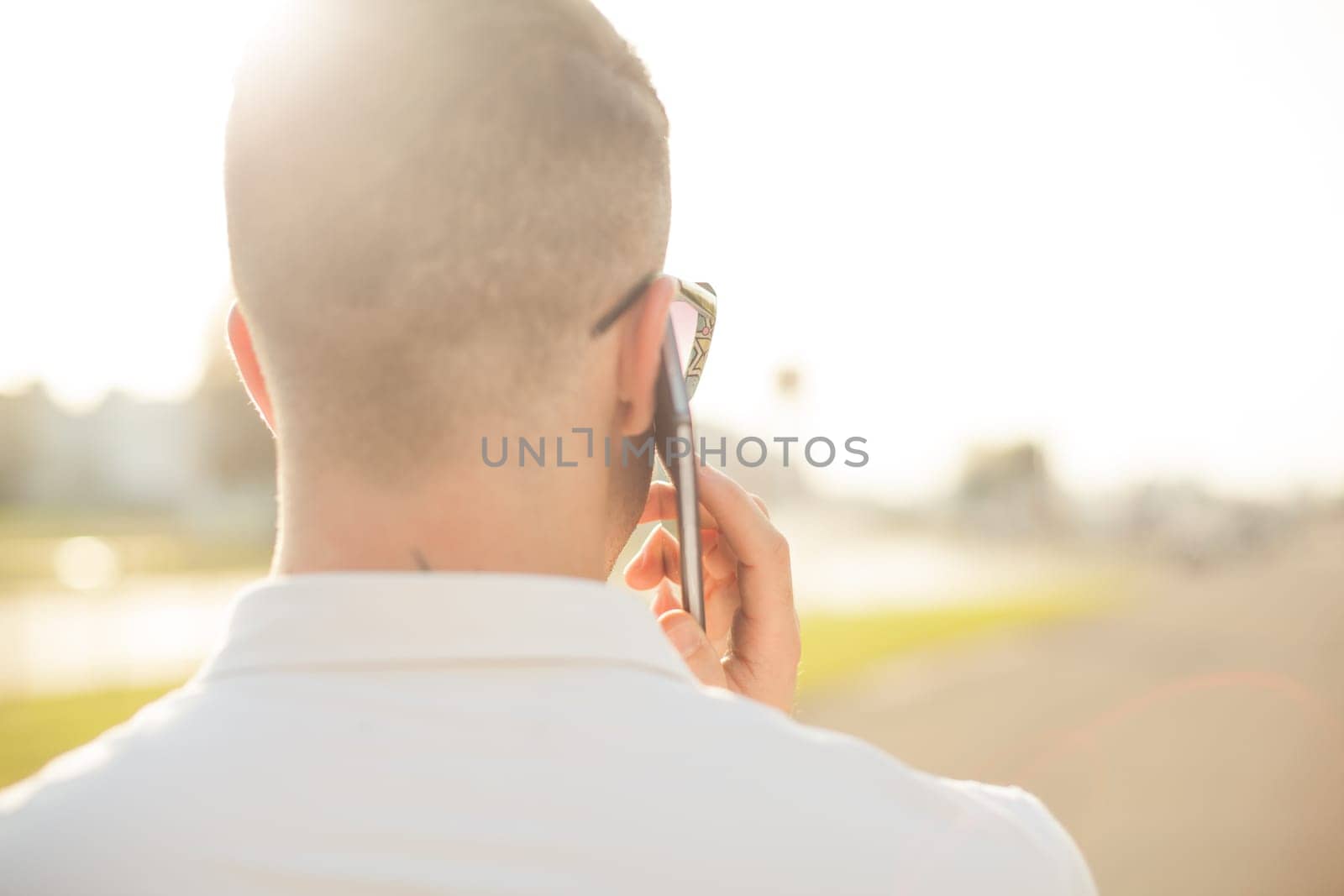 Man With Mobile Phone And Hat, In City, Urban Space, back view, outdoor