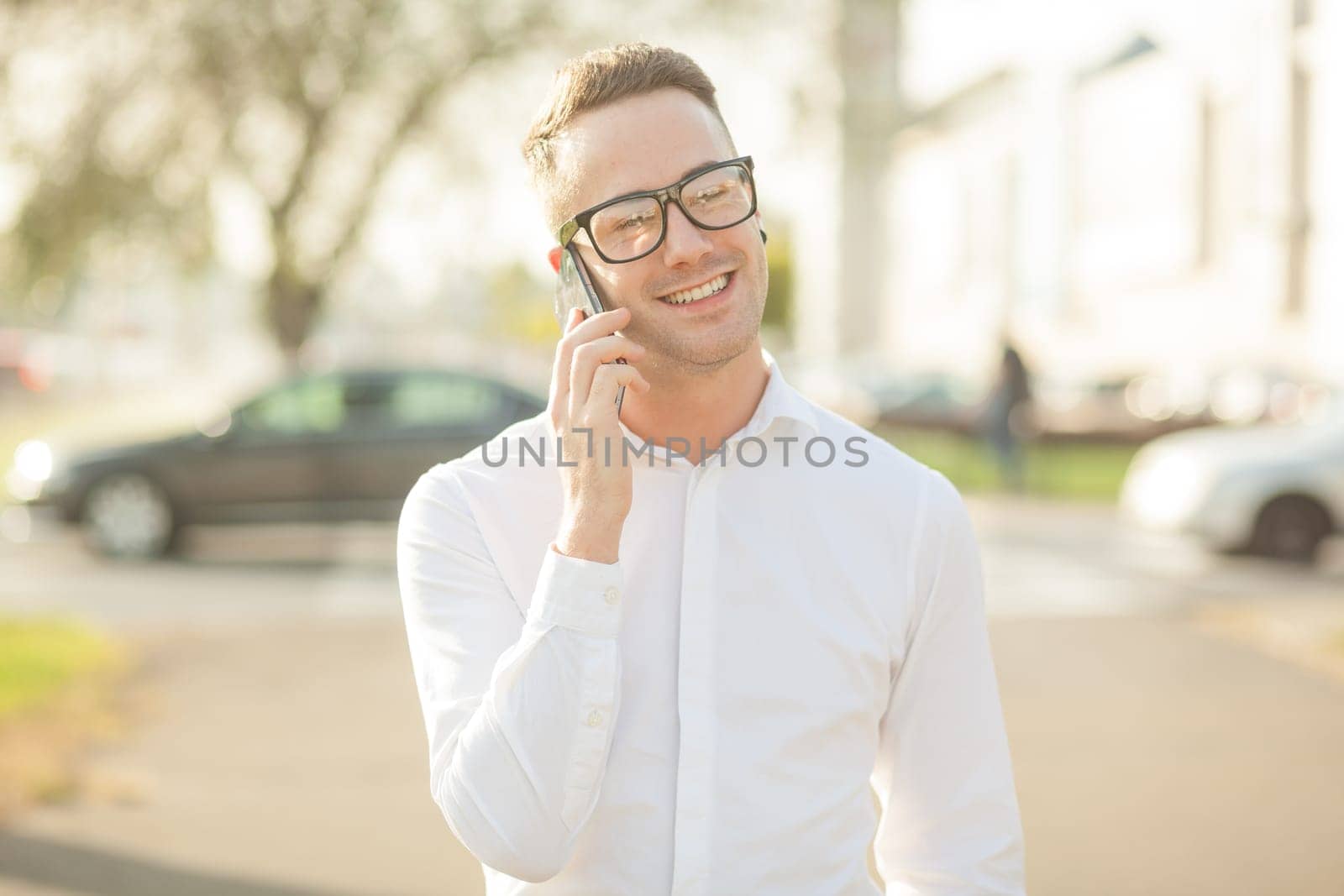 Man with glasses speak on mobile phone, In City, Urban Space, Park